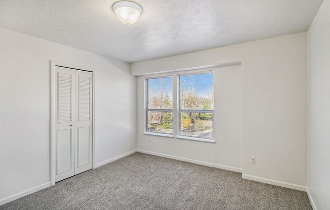 A room with a window and a door.
