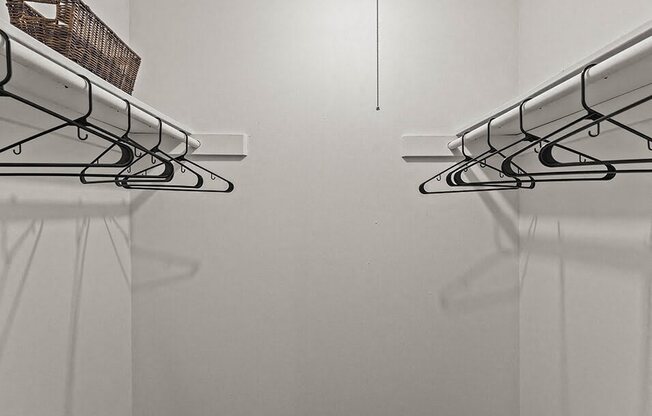 a laundry room with hanging racks on the wall