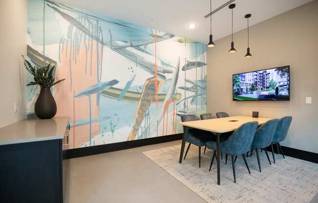 a dining room with a table and chairs and a tv on the wall