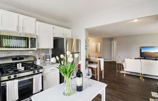 Modern kitchen with stainless steel appliances and white cabinetry at Ashford at Geneva Apartments in Geneva, IL – pet-friendly homes in the Far Northwest Chicago Suburbs