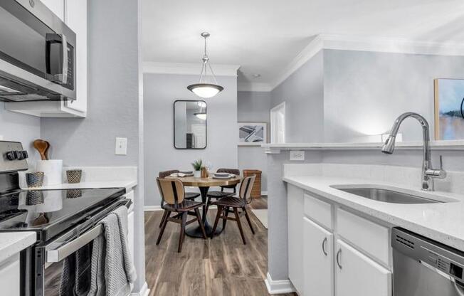 a kitchen with a sink and a stove and a table at Marina Point, Chattanooga