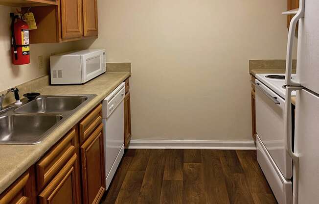 kitchen with white appliances and hardwood-style floors