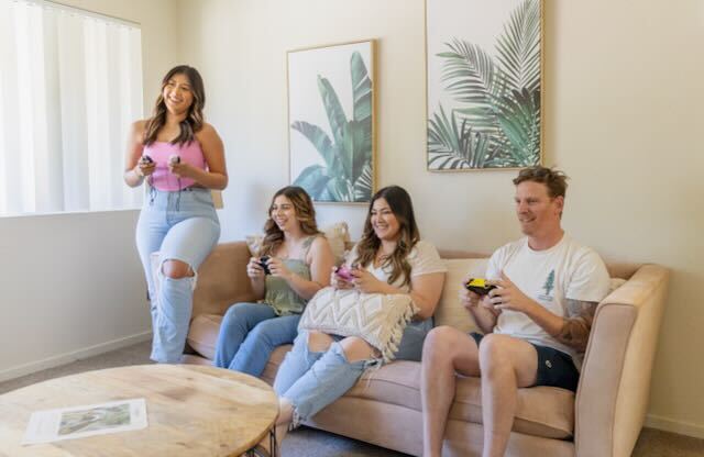 Residents play a game in a living room at Cranbrook.