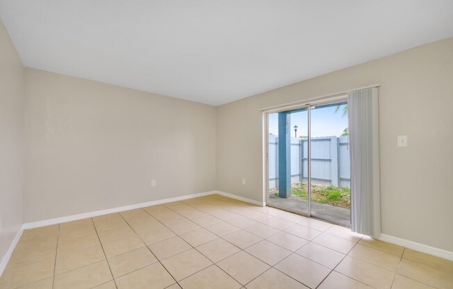 the living room has a sliding glass door to the patio