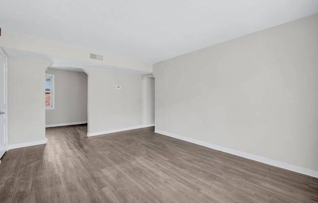 A room with wooden flooring and white walls at Highland Ridge Apartments, Capitol Heights, Maryland