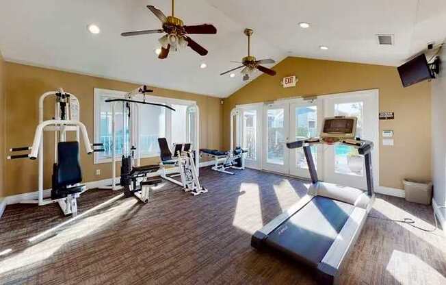 A cardio and weight training center with a treadmill, weights, and exercise equipment.