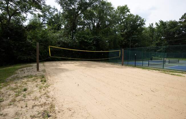 a tennis court with a yellow net in the middle of it