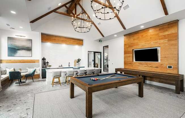 a game room with a pool table and a tv