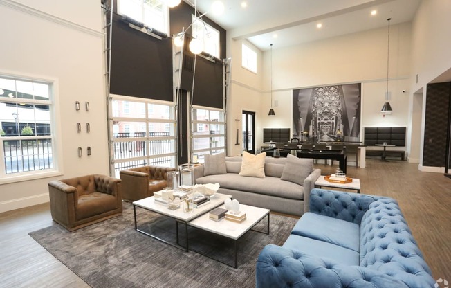 a living room with couches and chairs and a table at Century Baxter Avenue, Kentucky