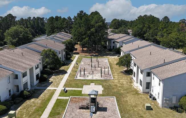A large white building complex with a courtyard in the middle.