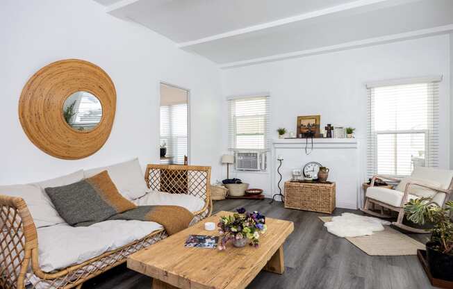 a living room with white walls and a wooden coffee table