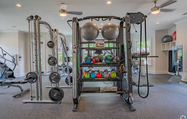 A home gym with a variety of equipment including weights and resistance bands.