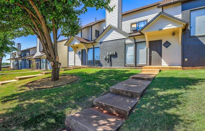 a group of houses with stairs in the grass at Diamond Ridge Townhomes, Oklahoma City, OK