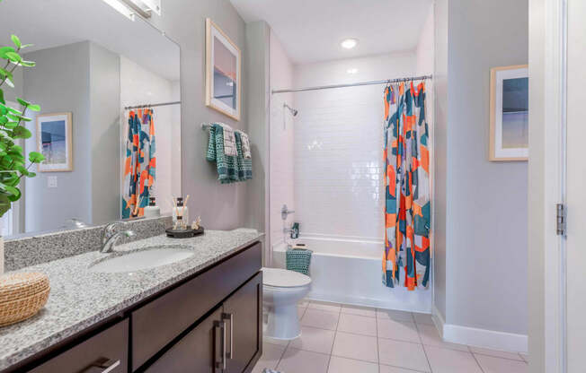 a bathroom with a shower toilet and sink