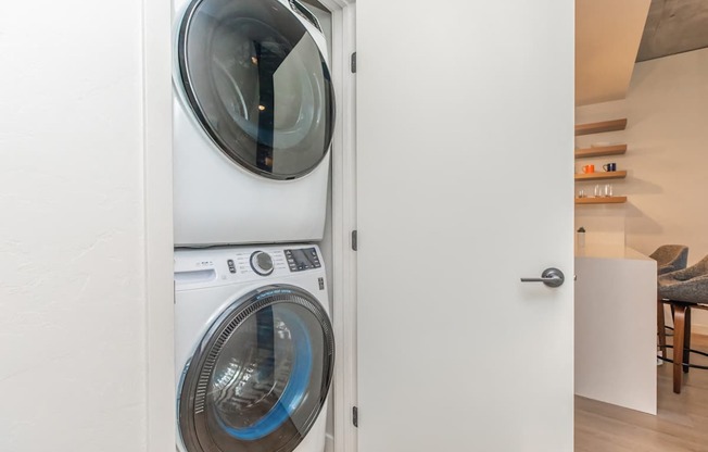 A white washing machine is in a doorway.