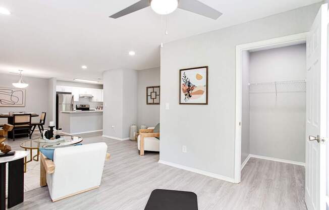 A living room with a white ceiling fan and a white couch.