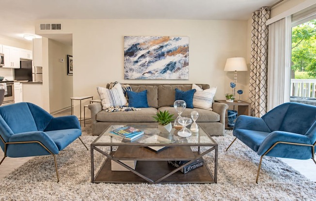 A living room with a blue chair and a coffee table.