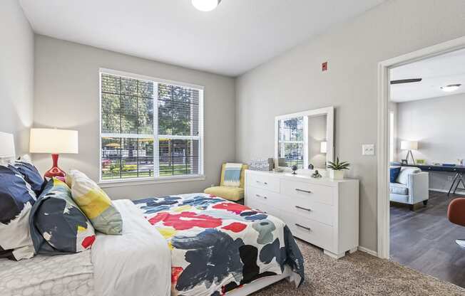 Bedroom with Large Double Window and Plush Carpeting
