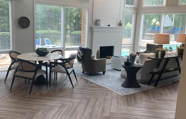 Leasing Office with view of fireplace, seating and pool visible through windows  at Huntington Apartments, North Carolina, 27560