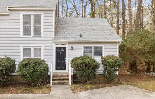 Front of townhome with stairs leading to front door