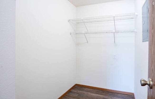 A white wall with a door and a shelf. Fargo, ND Westwood Estates