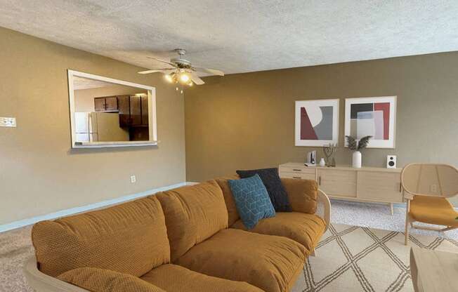 a living room with a couch and a ceiling fan