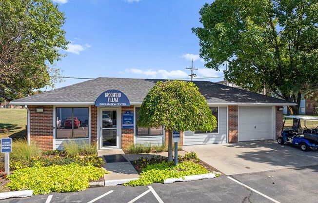 a brick office building with a tree in front of it