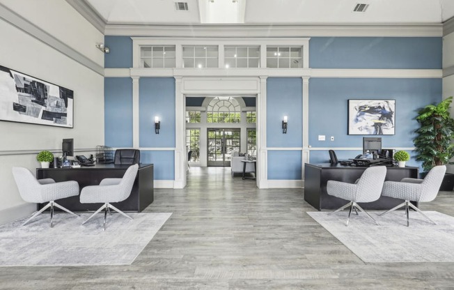 a lobby with blue walls and white furniture at Jefferson Creek in Irving, TX