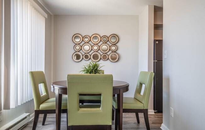 a dining room with a table and chairs
