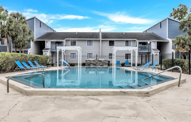 a swimming pool with a house in the background