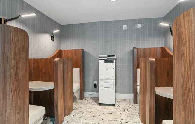 a bathroom with four stalls and a toilet and a sink at Link Apartments® Mint Street, Charlotte, North Carolina