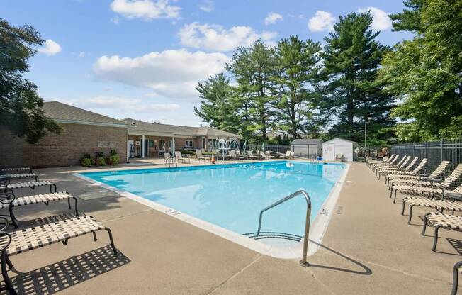 A large outdoor swimming pool surrounded by sun loungers.