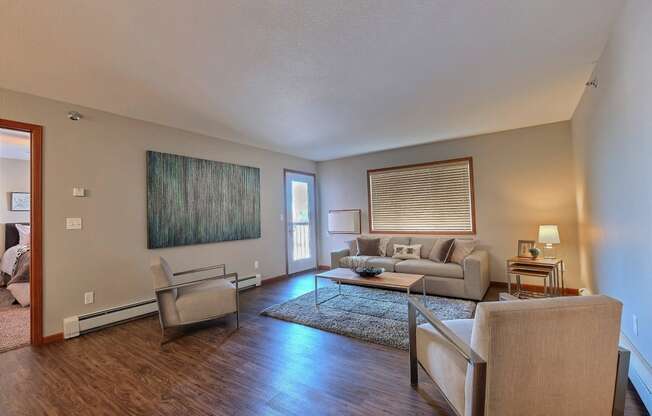 a living room with couches and chairs and a rug. Fargo, ND Urban Plains Apartments