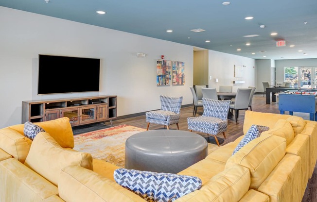 living room with a couch and chairs and a television at The Vue Apartments in Indianapolis