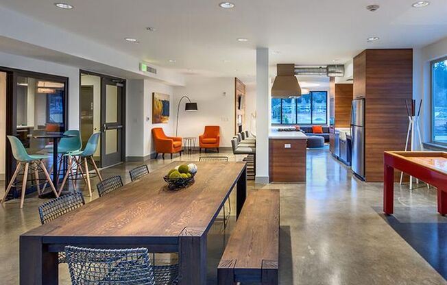 a kitchen and dining room with a wooden table and chairs