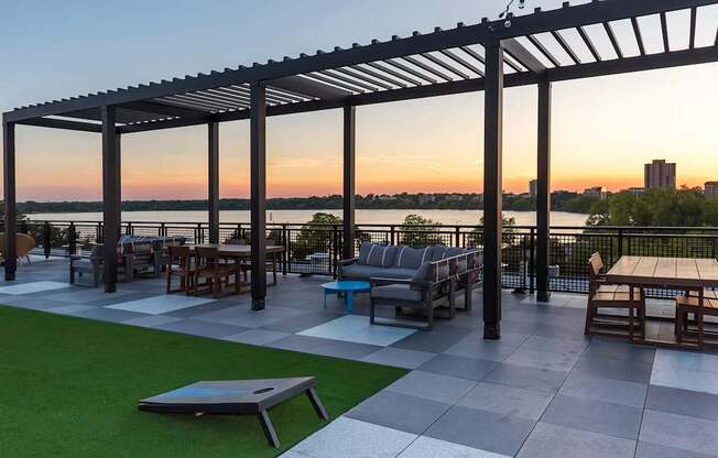 A patio with a table and chairs under a pergola.