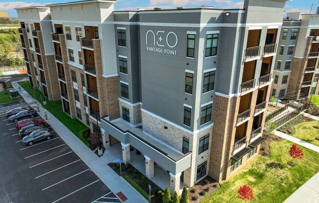 an aerial view of a large apartment building with a parking lot