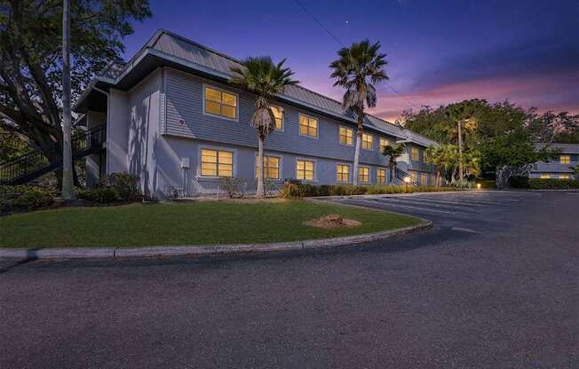 A large house with a palm tree in front.