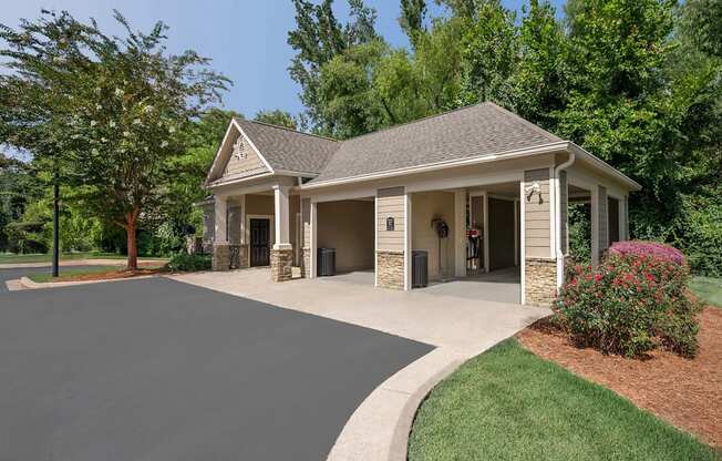 A house with a grey roof and a driveway in front.