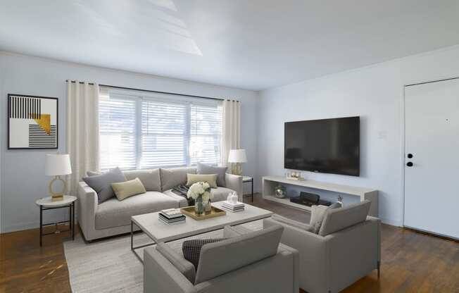 a living room with a couch and a coffee table at Ann Street Lofts, Mobile, 36604