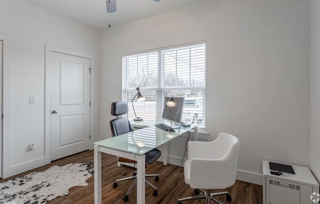 a home office with a desk and two chairs