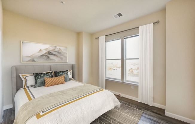 bedroom with bed, hardwood floors and large windows at city view apartments in washington dc