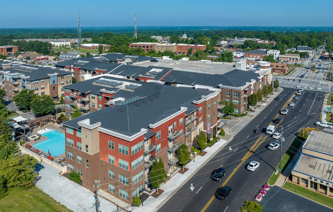 an aerial view of a building with a swimming pool