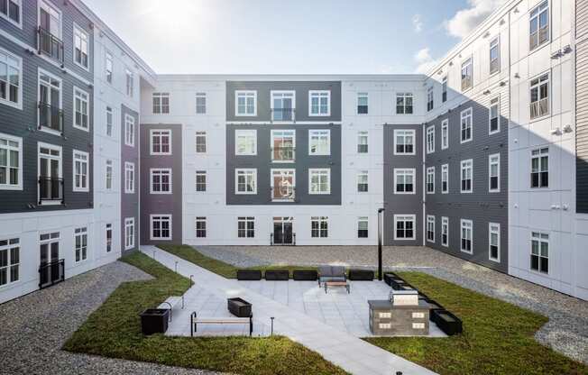 a view of an apartment building with a courtyard