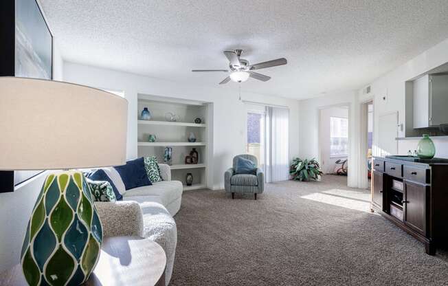 a living room with a couch and a ceiling fan