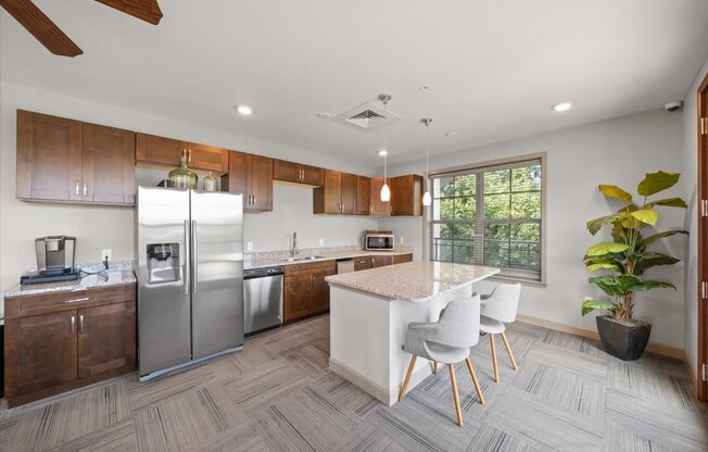 A modern kitchen with a white island and stainless steel appliances.