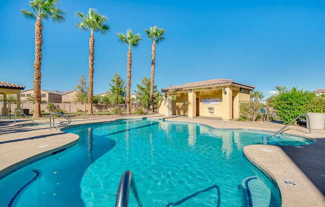 the swimming pool at the resort with palm trees