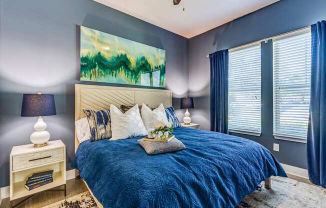 a bedroom with blue walls and a blue and white bed