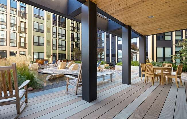 a patio with a table and chairs on a deck at Ann Arbor City Club, Ann Arbor, MI 48104