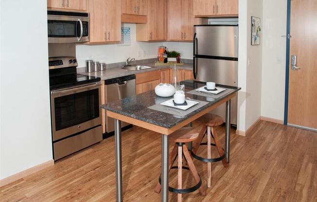 A kitchen with a table and chairs in the middle of it.
